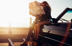 couple looking at a map with sunset in the background